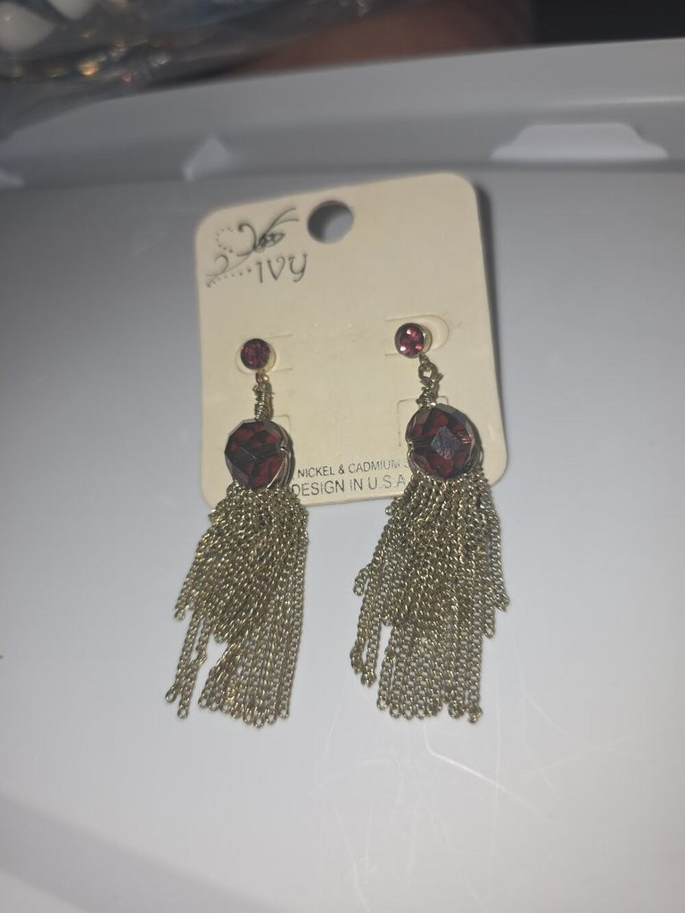 Ivy Gold Tone Tassel Earrings with Red Gemstones
